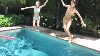 Two Bikini Teens challenging each other in pool