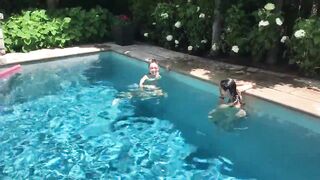 Two Bikini Teens challenging each other in pool