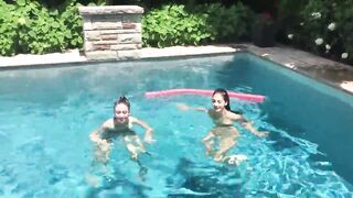 Two Bikini Teens challenging each other in pool