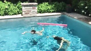 Two Bikini Teens challenging each other in pool