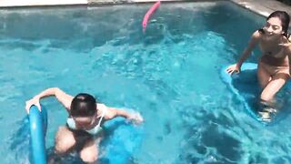 Two Bikini Teens challenging each other in pool