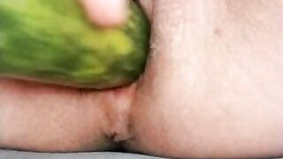 Ftm masturbates hairless noisy pussy with a cucumber close up.