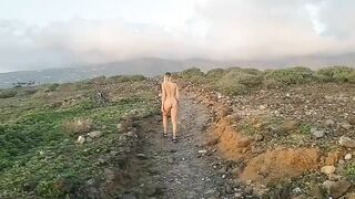 Naked girl in the road to mountains