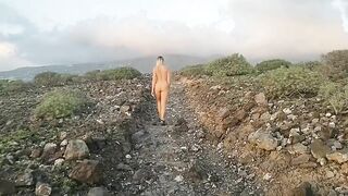 Naked girl in the road to mountains