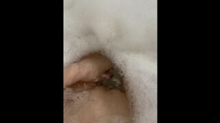 Glass dildo in the tub