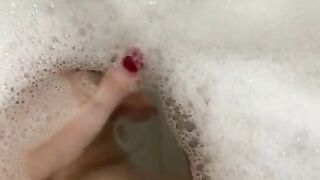 Glass dildo in the tub