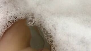 Glass dildo in the tub