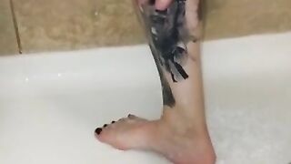 Milf washes feet in the shower