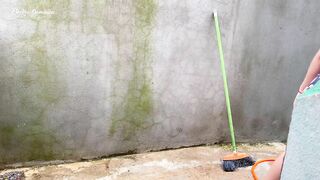 Maid in pajamas cleaning the yard