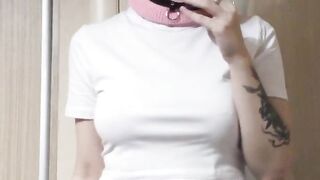 smoking girl in a pink balaclava and a cat mask