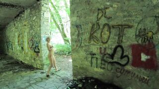 Naked girl walks through an abandoned building